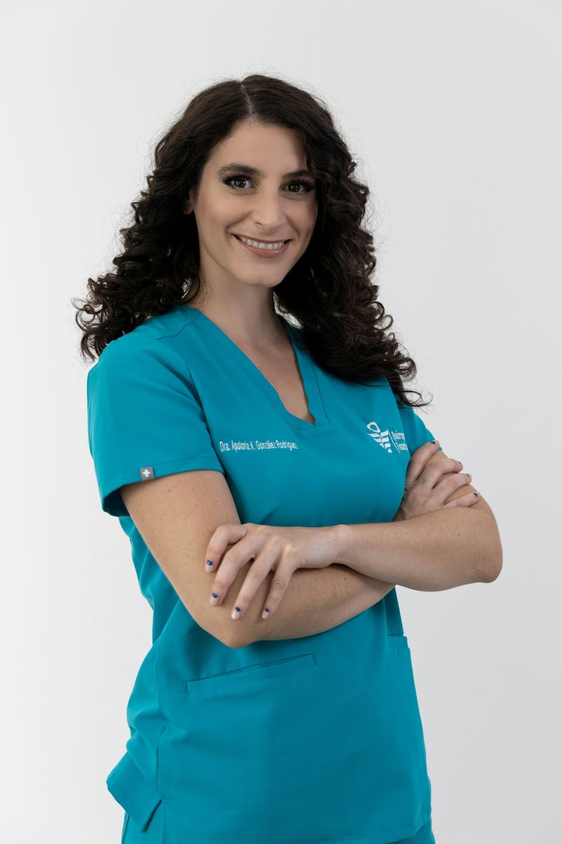 Doctor in teal scrubs smiling